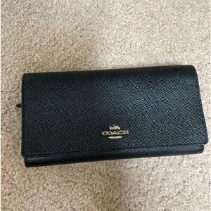 Used black trifold coach wallet.